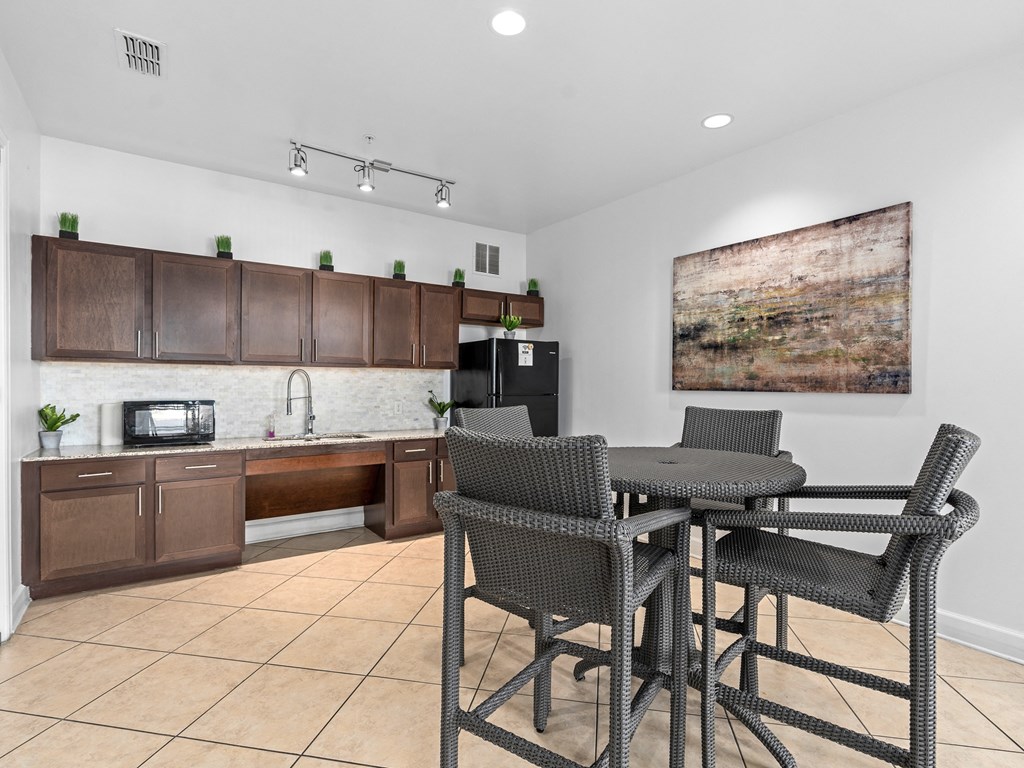 a kitchen and dining area with a table and chairs at Lake Lofts at Deerwood, Jacksonville, FL, 32216