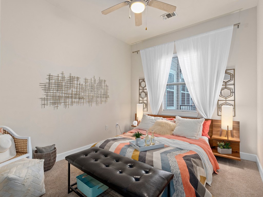 a bedroom with a bed and a window and a ceiling fan at Lake Lofts at Deerwood, Jacksonville, FL, 32216