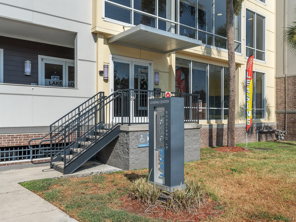 the front of a building with a sign in front of itat Lake Lofts at Deerwood, Jacksonville, FL