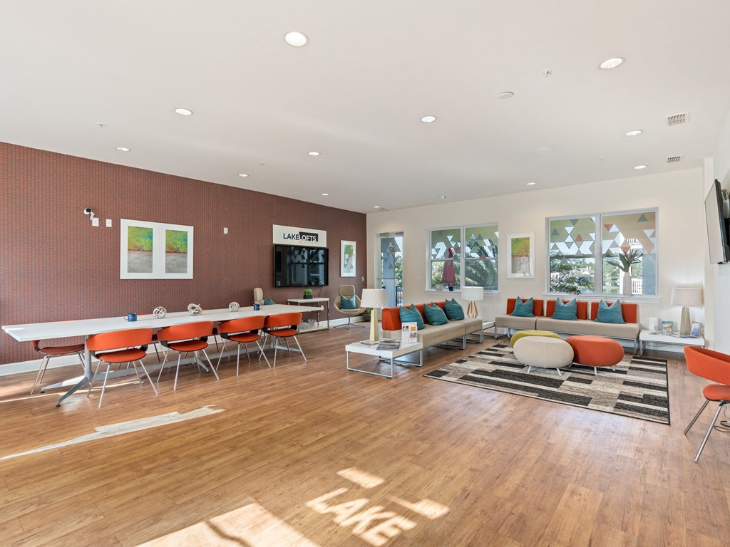 a living room with tables and chairs and a couch at Lake Lofts at Deerwood, Jacksonville, Florida