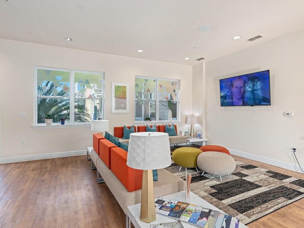 a living room with a couch and a table at Lake Lofts at Deerwood, Jacksonville, FL, 32216