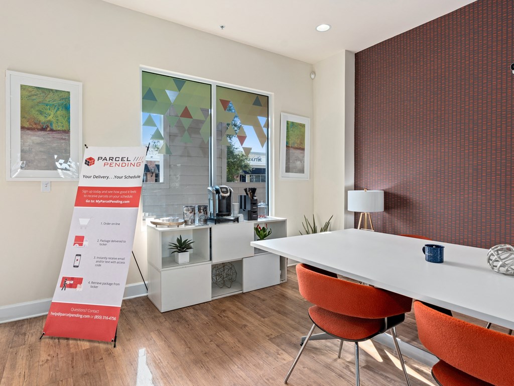 a conference room with a table and chairs and a sign at Lake Lofts at Deerwood, Jacksonville, FL