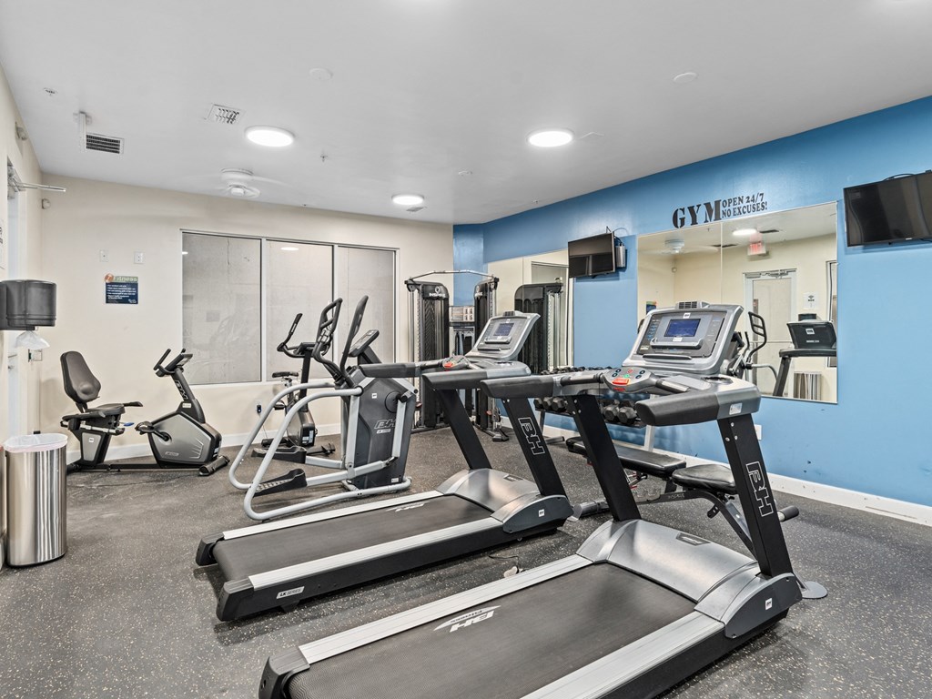 a gym with treadmills and other exercise equipment in a building at Lake Lofts at Deerwood, Jacksonville, FL