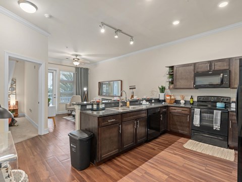 a kitchen with a large island and a living room