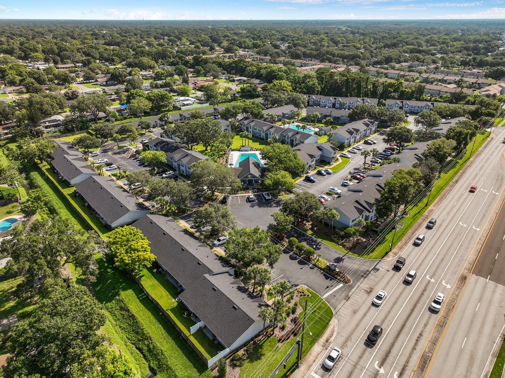 an aerial view of a neighborhood with cars parked in a parking lot at Oak Reserve at Winter Park, Winter Park, FL
