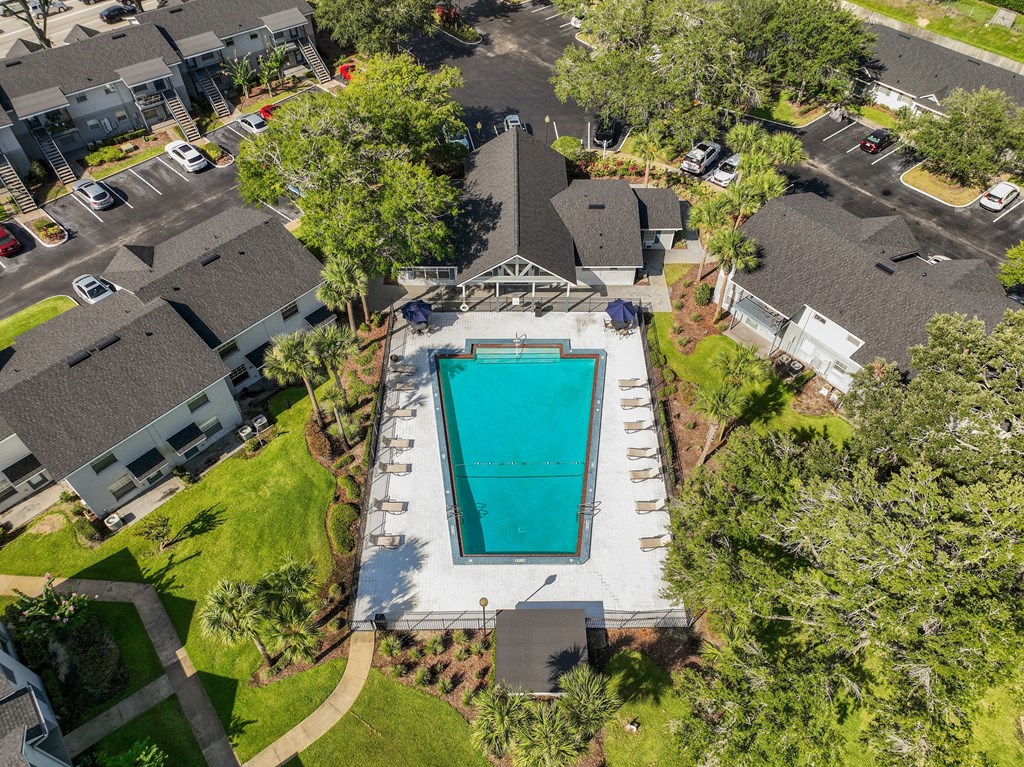 a birds eye view of a swimming pool in a neighborhood with houses and trees at Oak Reserve at Winter Park, Winter Park