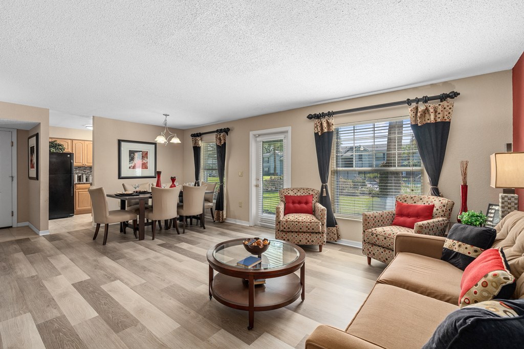 a living room with couches and chairs and a dining room table at Oak Reserve at Winter Park, Florida, 32792