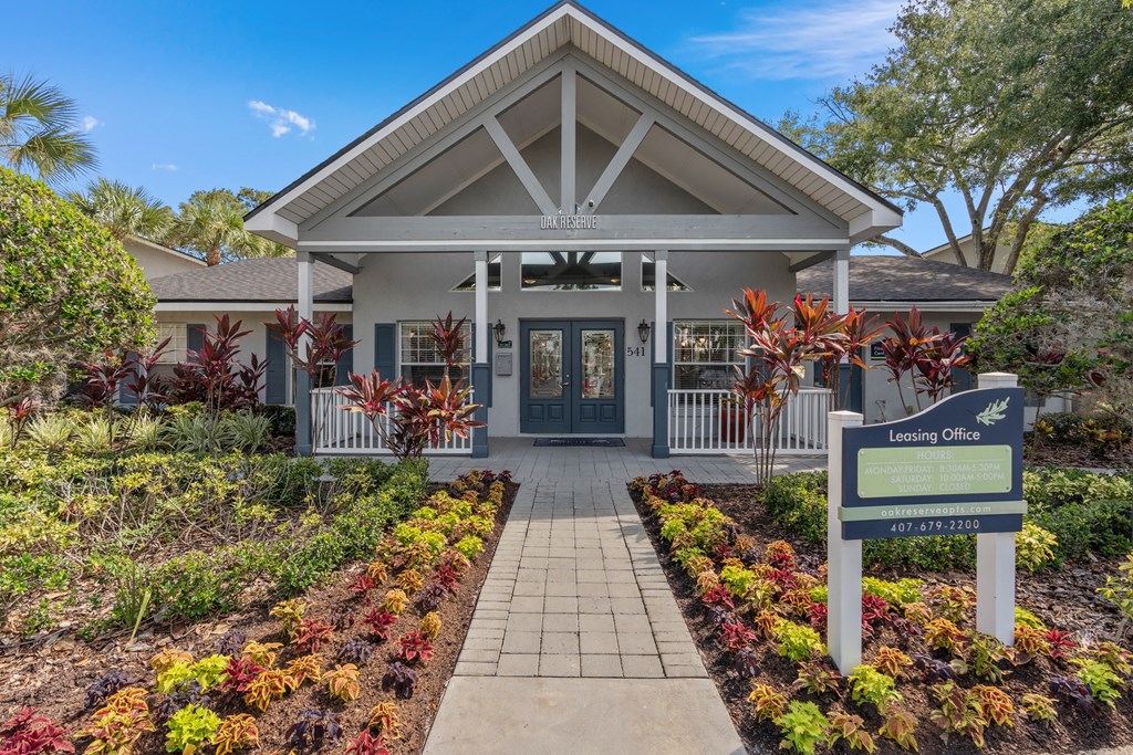 the entrance to a building with a sign in front of it at Oak Reserve at Winter Park, Florida