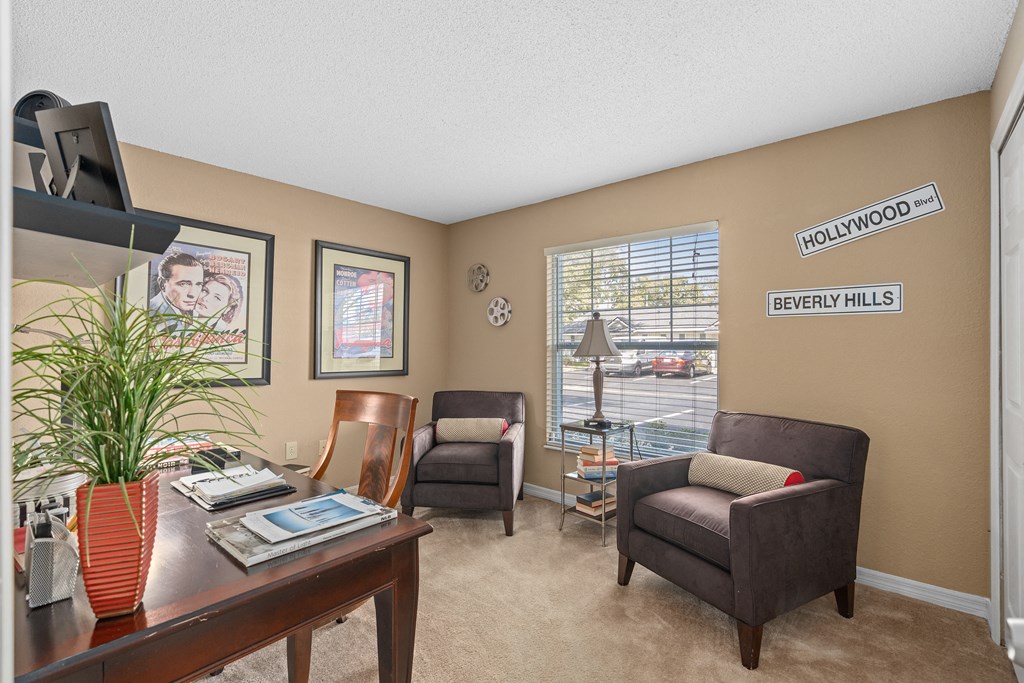 a living room with a desk and chairs and a window at Oak Reserve at Winter Park, Winter Park