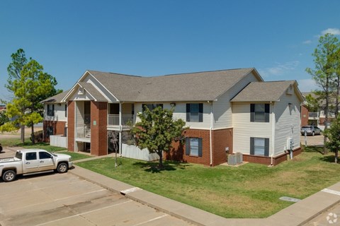 an apartment building with a truck parked in front of it at Chapel Ridge of Stillwater, Stillwater, OK, 74075