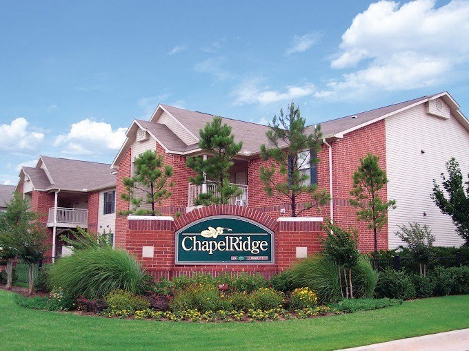 a building with a sign in front of it at Chapel Ridge of Stillwater, Stillwater, Oklahoma