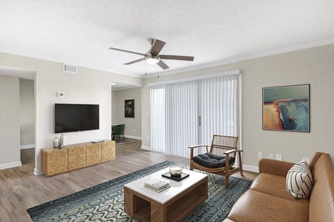a living room with a couch and a ceiling fan at Lakeside Villas, Orlando, FL 32817