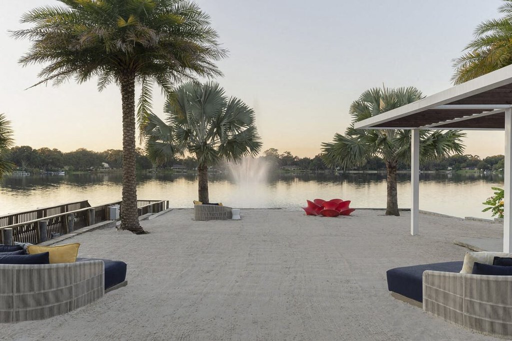 a dock with palm trees and a fountain  and a lake at Lakeside Villas, Orlando Florida