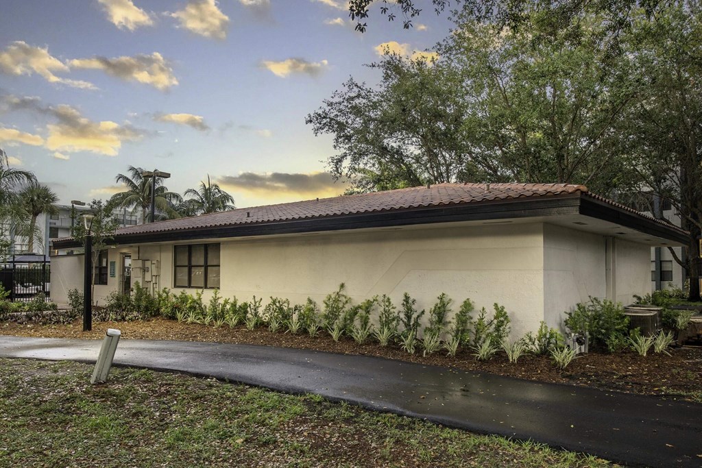 a house with a driveway and trees in the background  at Club at Emerald Waters, Hollywood, 33021