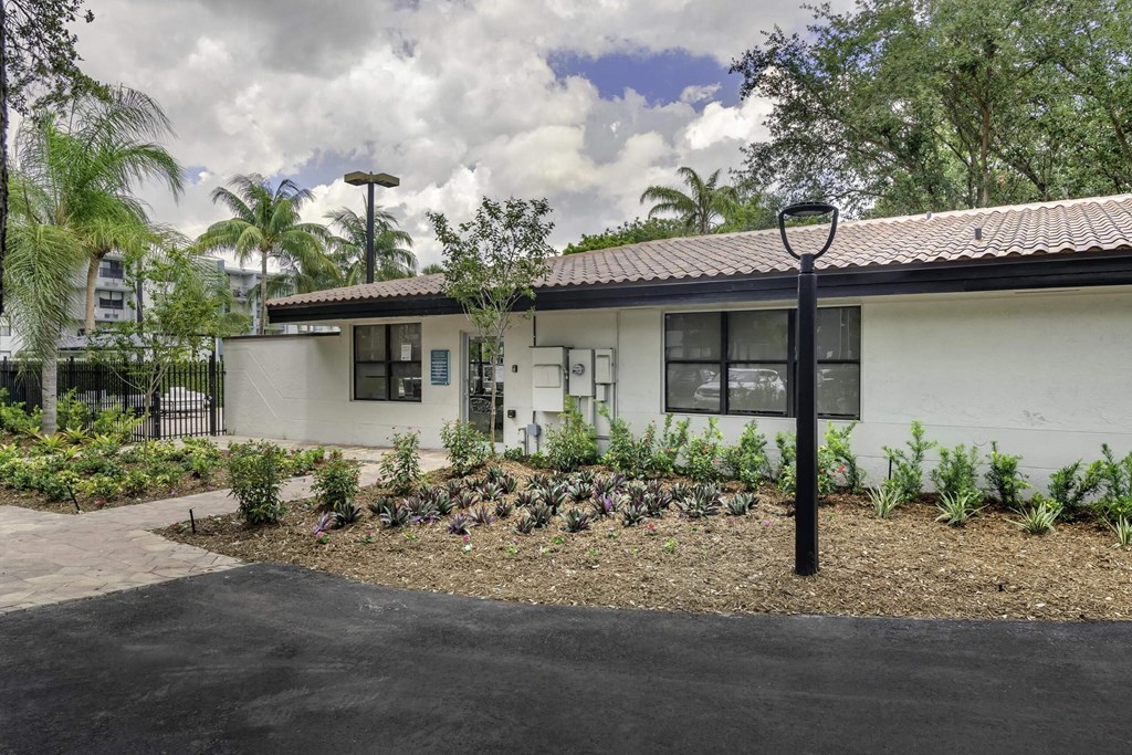a white house with a garden in front of it  at Club at Emerald Waters, Florida