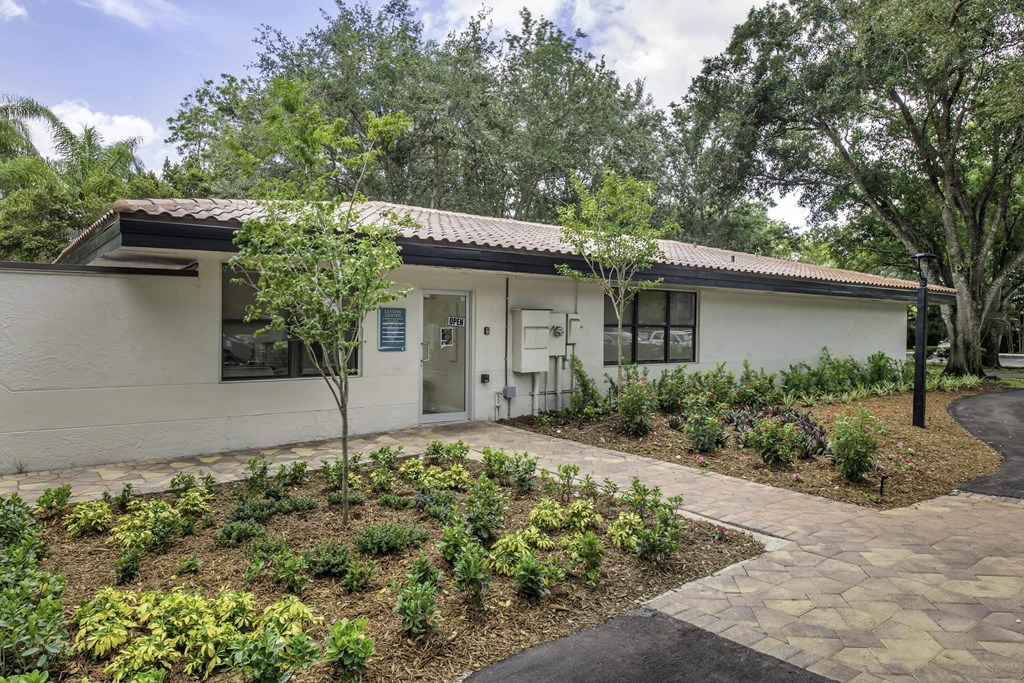 a white house with a garden in front of it  at Club at Emerald Waters, Hollywood, Florida