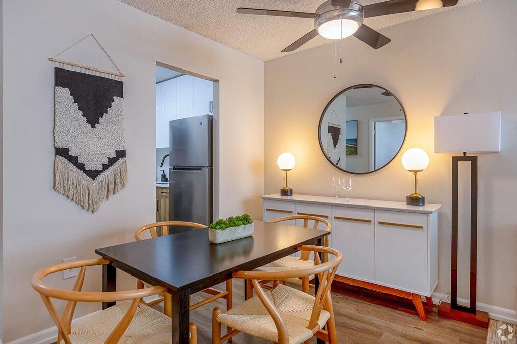 a dining area with a table and chairs and a ceiling fan  at Club at Emerald Waters, Hollywood, Florida