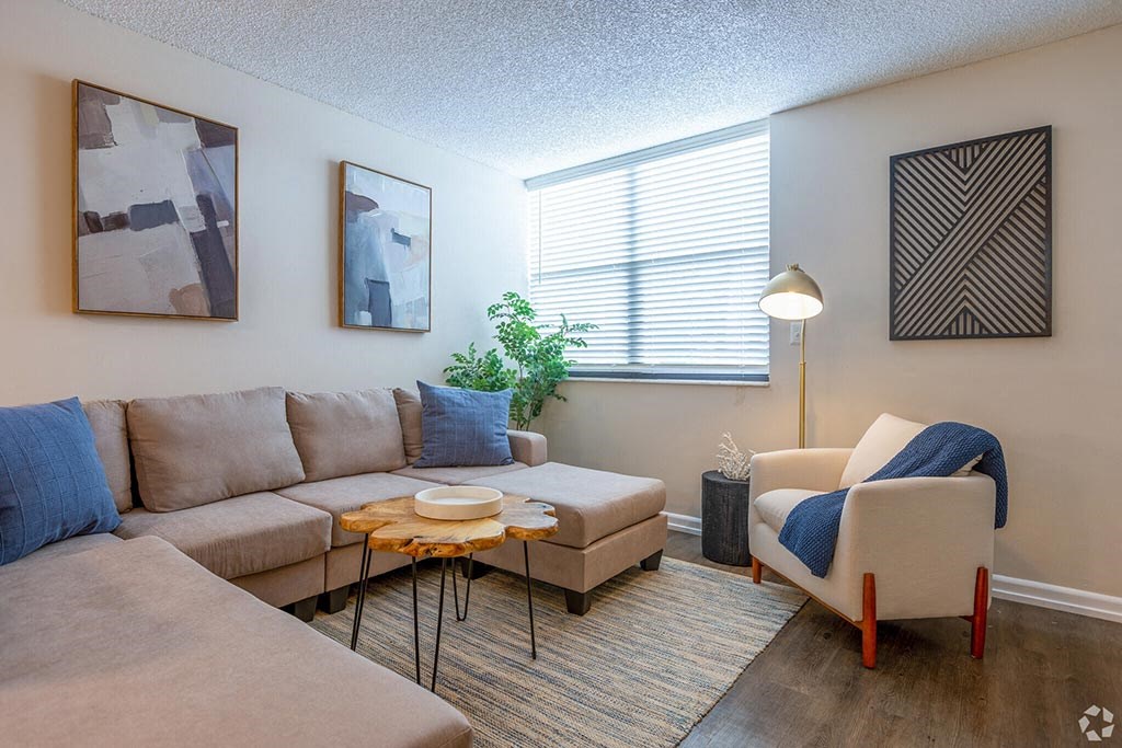 a living room with a couch chair and coffee table  at Club at Emerald Waters, Hollywood, 33021