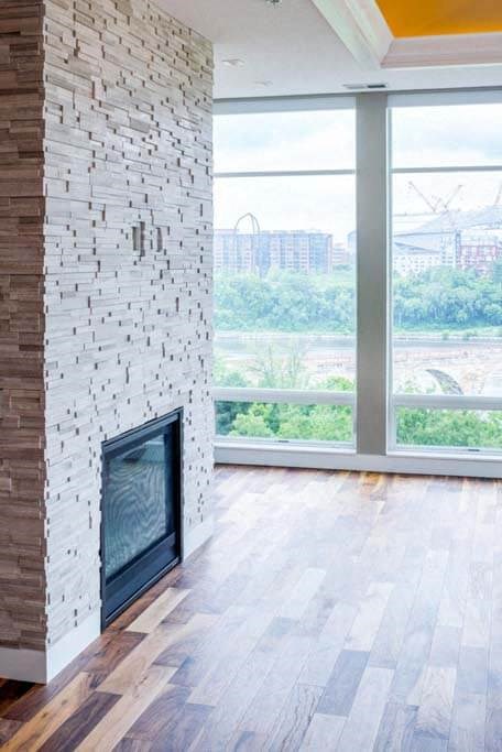 a living room with a fireplace and a large window