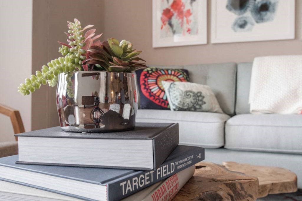 a table with a vase and a book on it