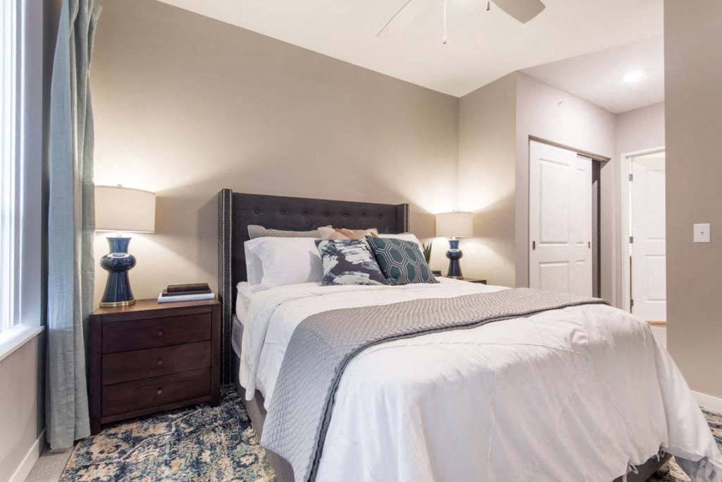 a bedroom with a bed and a ceiling fan