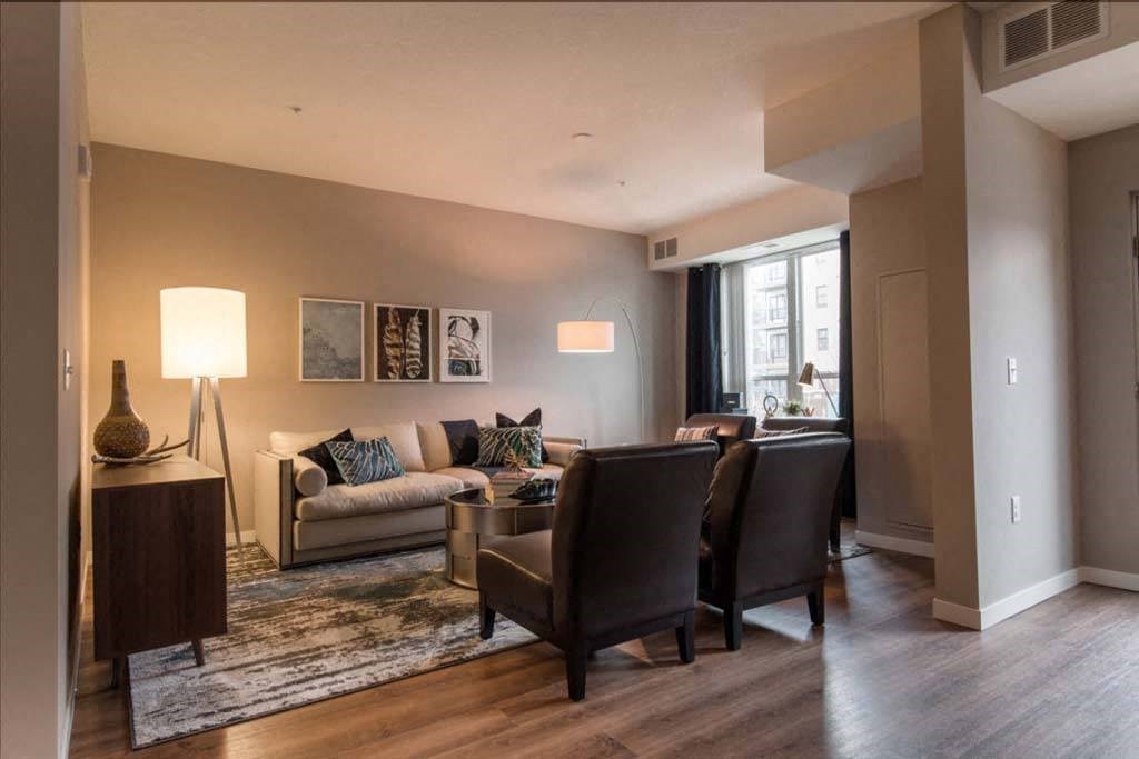 a living room with a couch chairs and a table