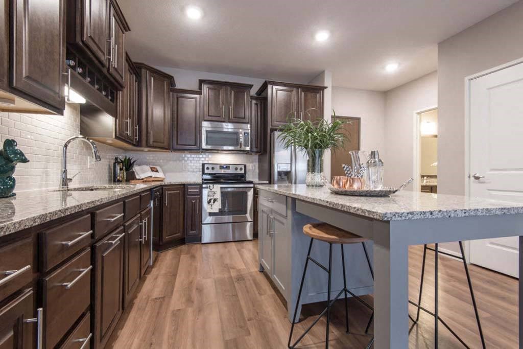 a kitchen with a counter top and a stove top oven