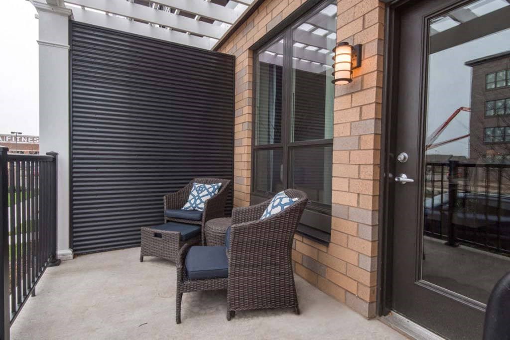a patio with two chairs and a table
