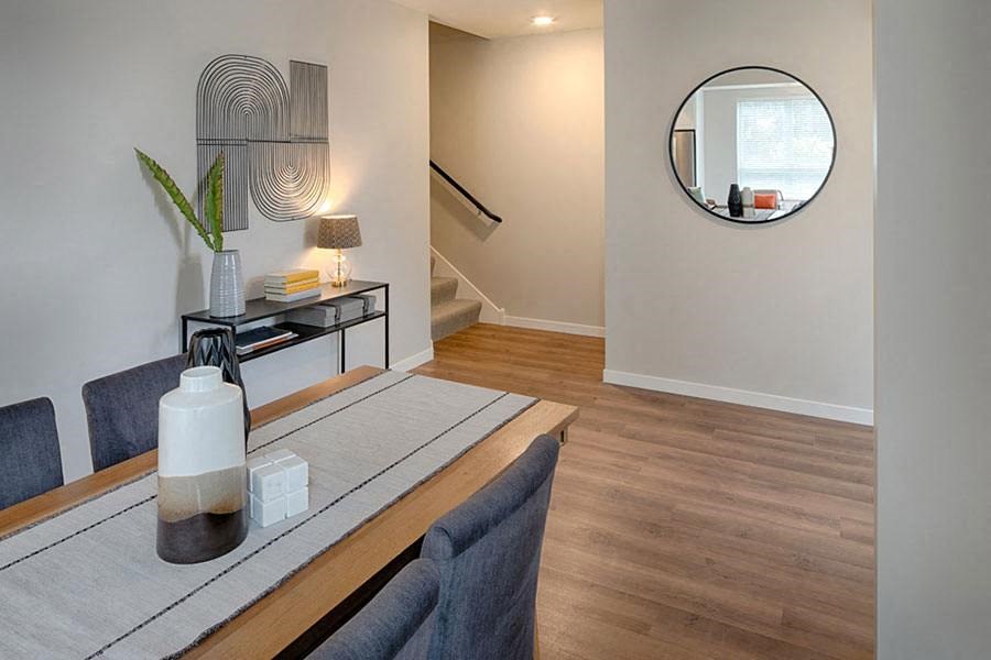 a room with a table and chairs and a mirror