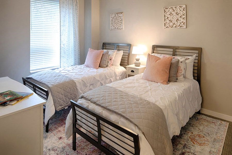 a bedroom with two beds and a desk