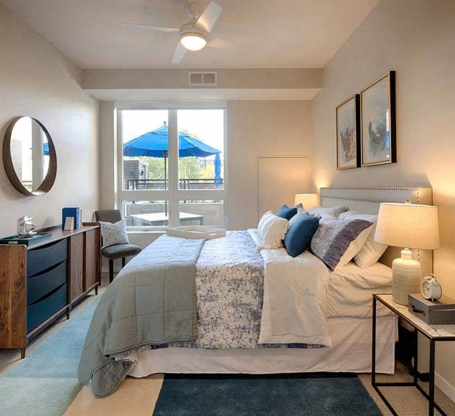 a bedroom with a large bed and a large window