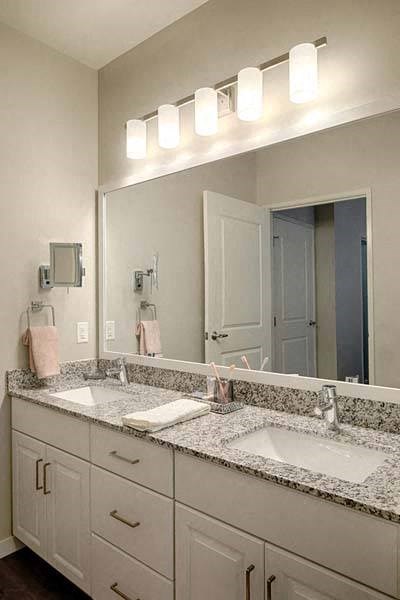a bathroom with two sinks and a large mirror