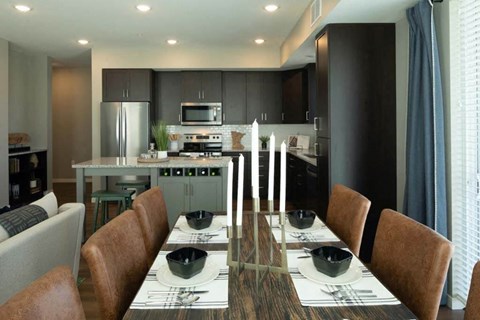 a kitchen and dining room with a table and chairs