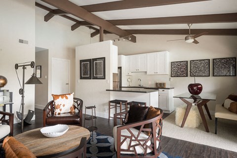 A modern living room with a wooden table and chairs.