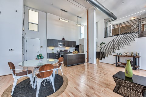 A modern dining room with a glass table and chairs.