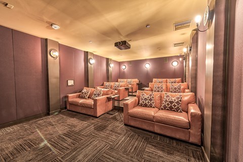 A room with pink couches and a carpeted floor.