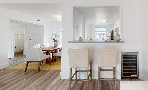 A kitchen with a table and chairs.