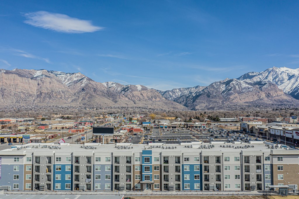 an aerial view of a city with mountains in the background