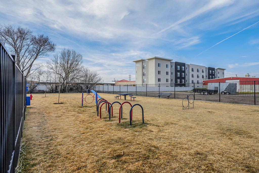 a playground in a park with a building in the background