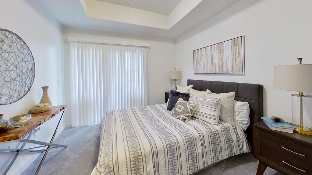 a bedroom with a bed and a dresser and a window