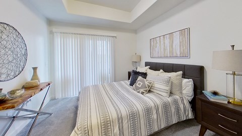 a bedroom with a bed and a dresser and a window