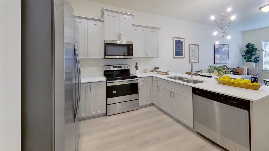 a kitchen with stainless steel appliances and white cabinets