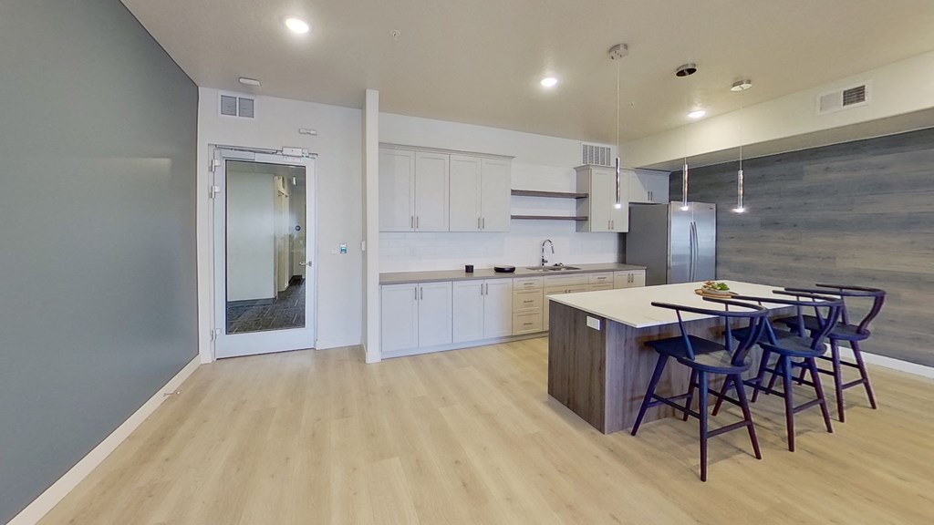 a kitchen and dining area with a table and chairs in a house