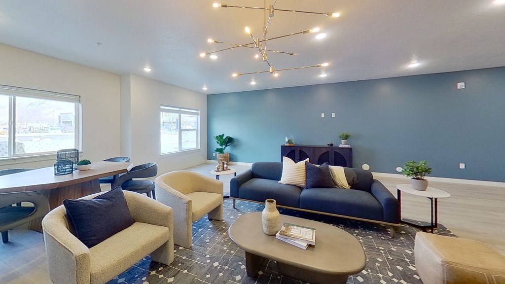 a living room with couches chairs and a table