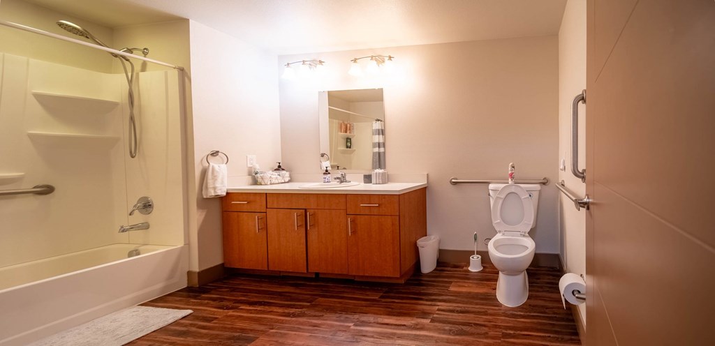 A bathroom with a toilet, sink, and shower.