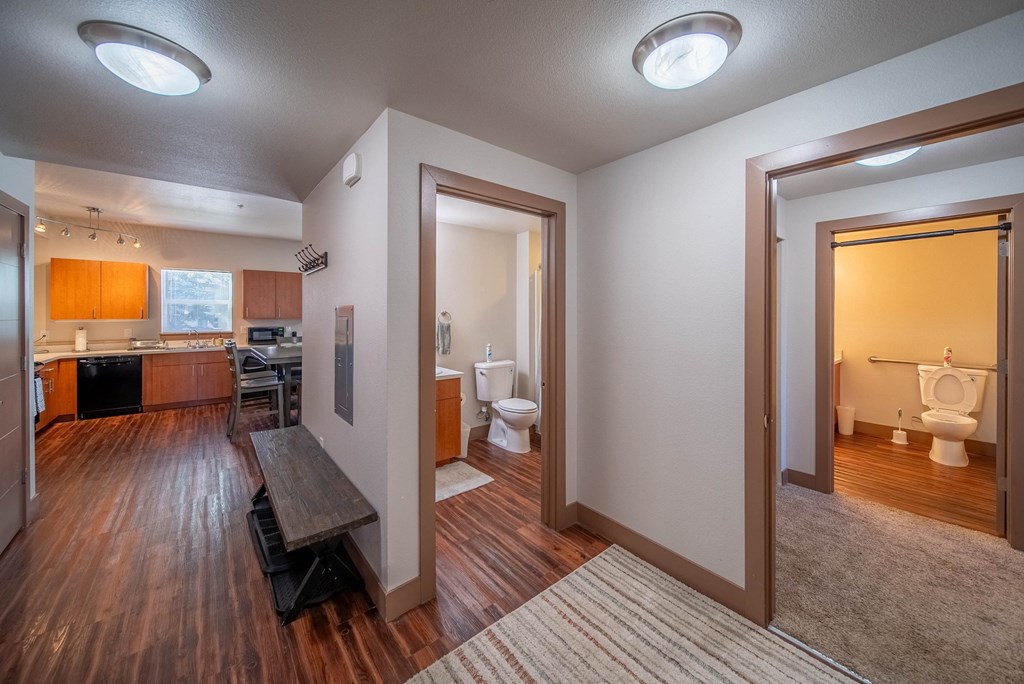 A modern home interior with a kitchen, dining area, and bathrooms.