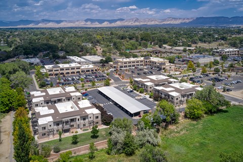 an aerial view of a city with buildings and a parking lot