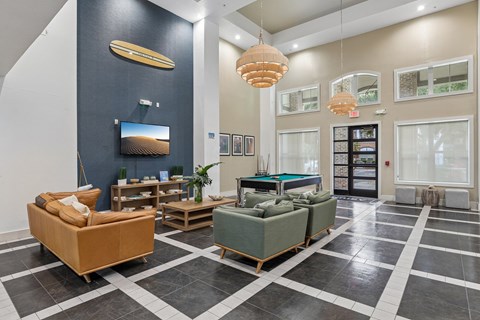 A living room with a pool table and a television.