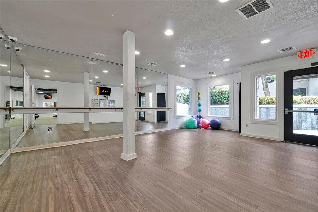 the fitness center is equipped with a dance floor and mirrors