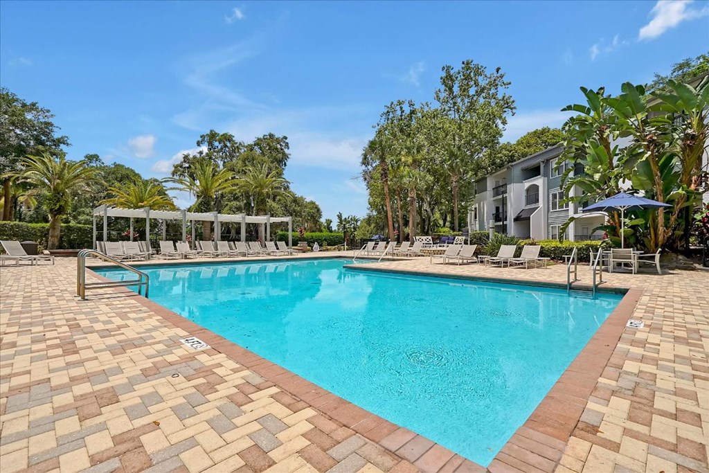 a large swimming pool with chairs around it